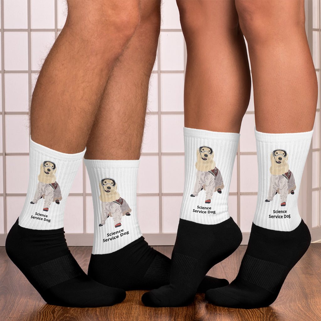 Two people from the knees down wearing socks that are white on the top and black on the bottom with a picture of Sampson wearing lab gear and the socks say, "Science Service Dog."